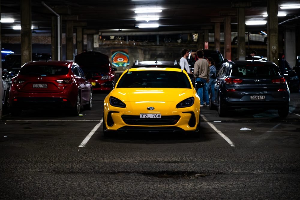Ferraris, imports and modified cars under carpark lighting at a late-night Sydney car meet (frame 2 of 40)
