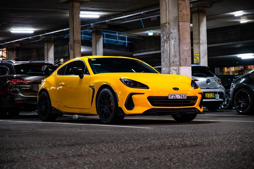 Ferraris, imports and modified cars under carpark lighting at a late-night Sydney car meet (frame 3 of 40)