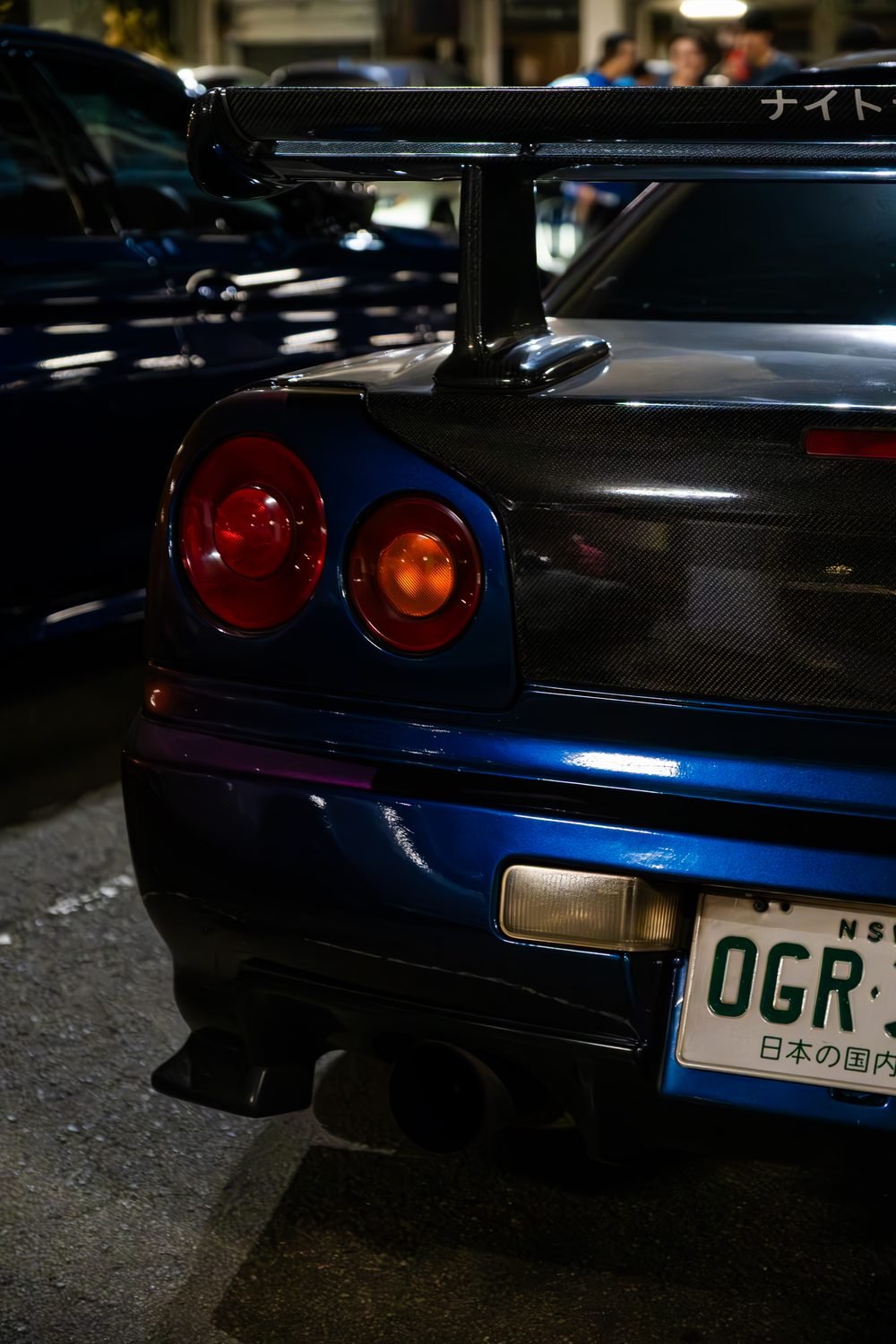Ferraris, imports and modified cars under carpark lighting at a late-night Sydney car meet (frame 6 of 40)