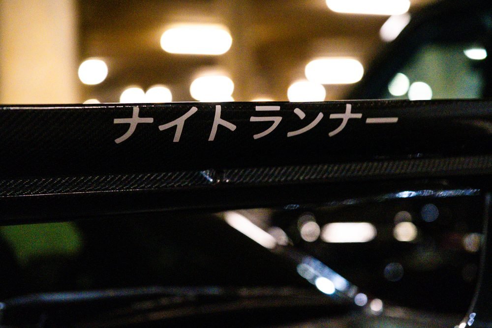 Ferraris, imports and modified cars under carpark lighting at a late-night Sydney car meet (frame 7 of 40)