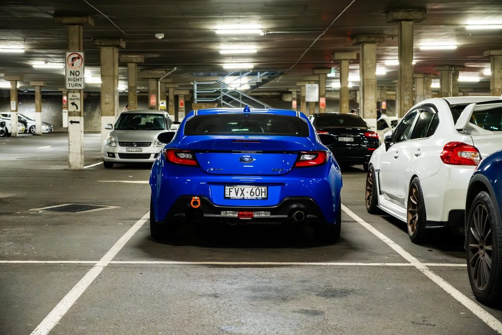 Ferraris, imports and modified cars under carpark lighting at a late-night Sydney car meet (frame 10 of 40)