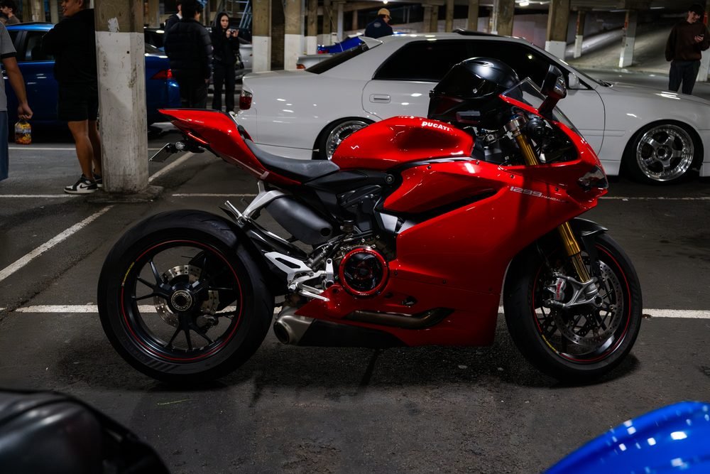 Ferraris, imports and modified cars under carpark lighting at a late-night Sydney car meet (frame 14 of 40)