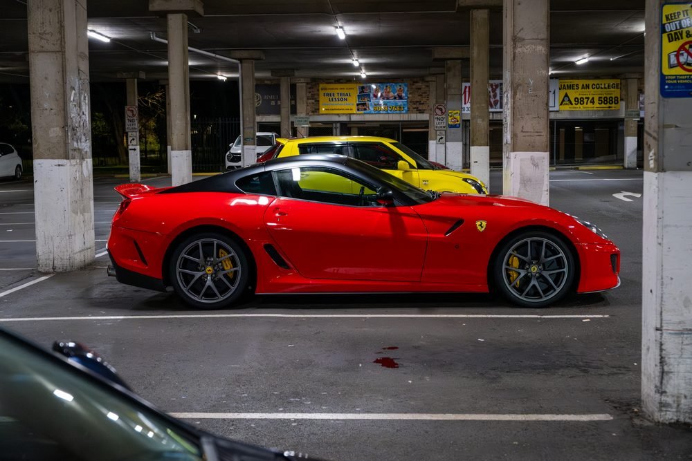 Ferraris, imports and modified cars under carpark lighting at a late-night Sydney car meet (frame 19 of 40)