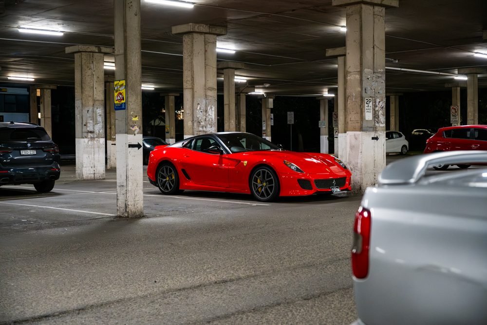 Ferraris, imports and modified cars under carpark lighting at a late-night Sydney car meet (frame 30 of 40)