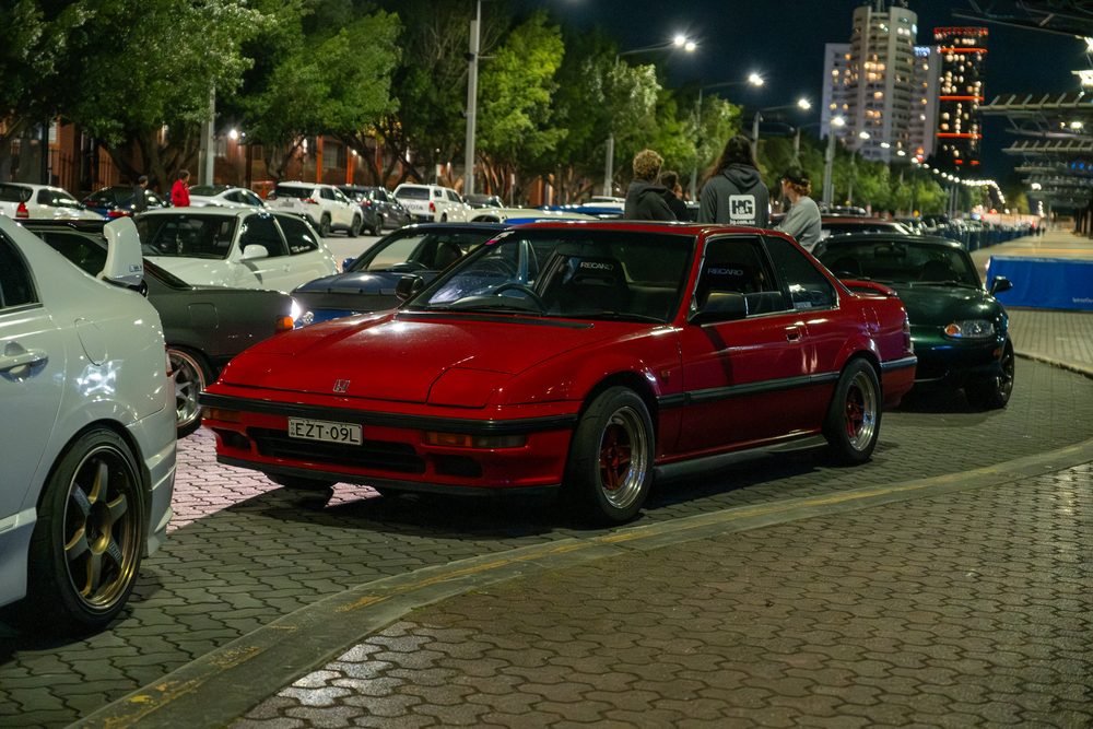 Ferraris, imports and modified cars under carpark lighting at a late-night Sydney car meet (frame 31 of 40)