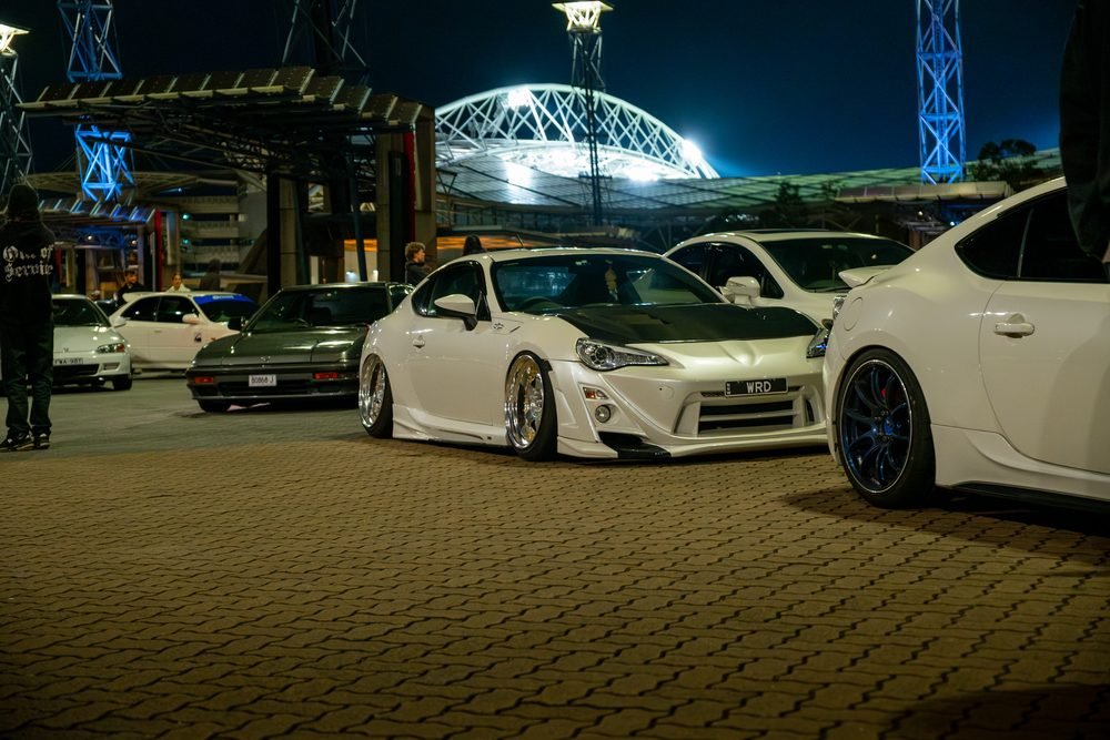 Ferraris, imports and modified cars under carpark lighting at a late-night Sydney car meet (frame 32 of 40)