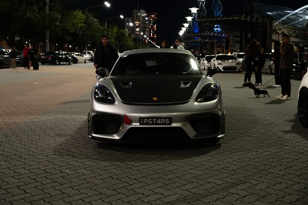 Ferraris, imports and modified cars under carpark lighting at a late-night Sydney car meet (frame 33 of 40)