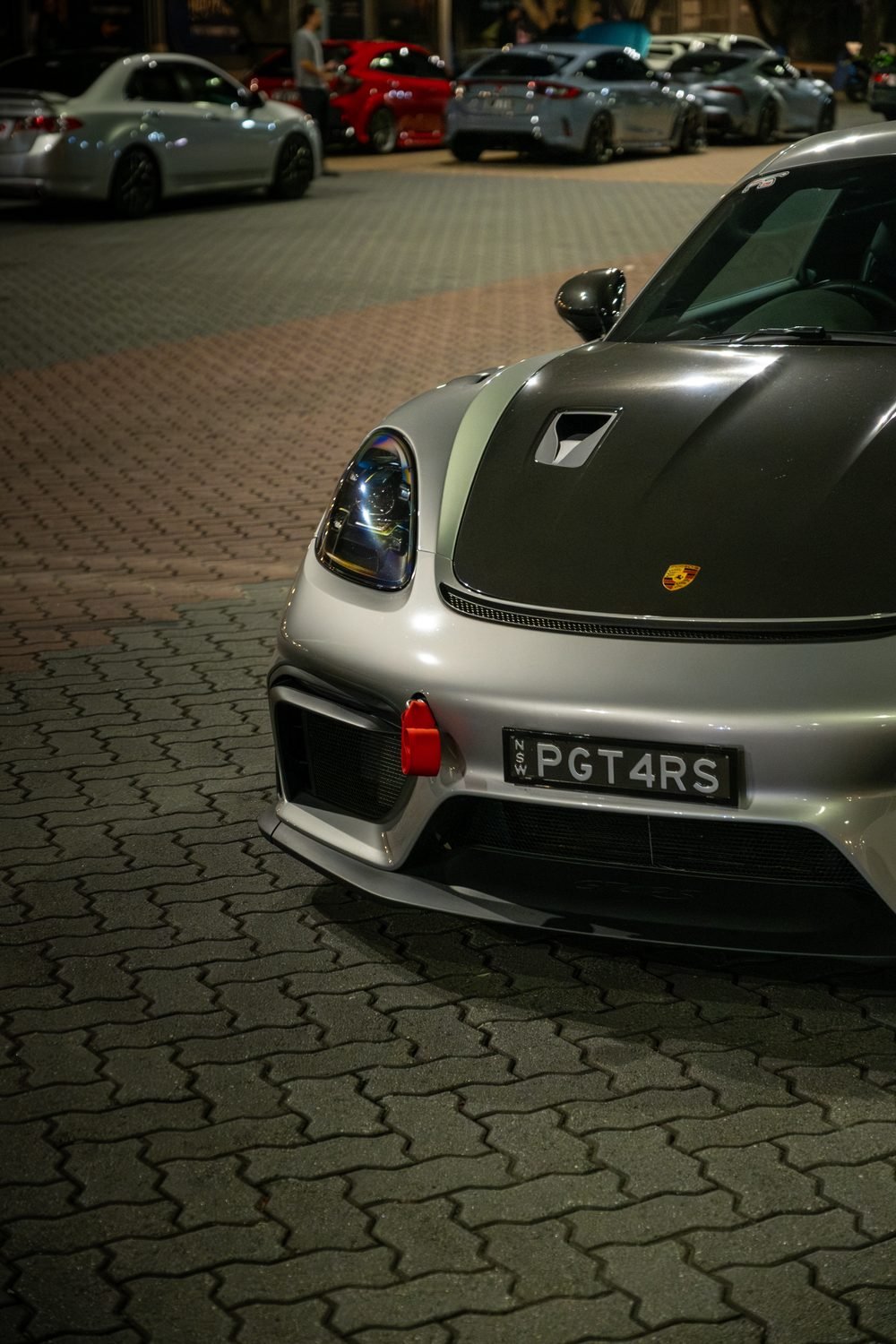 Ferraris, imports and modified cars under carpark lighting at a late-night Sydney car meet (frame 34 of 40)