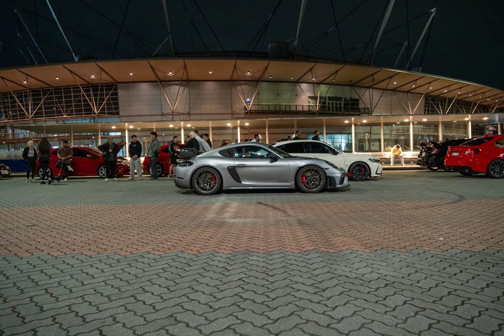 Ferraris, imports and modified cars under carpark lighting at a late-night Sydney car meet (frame 36 of 40)
