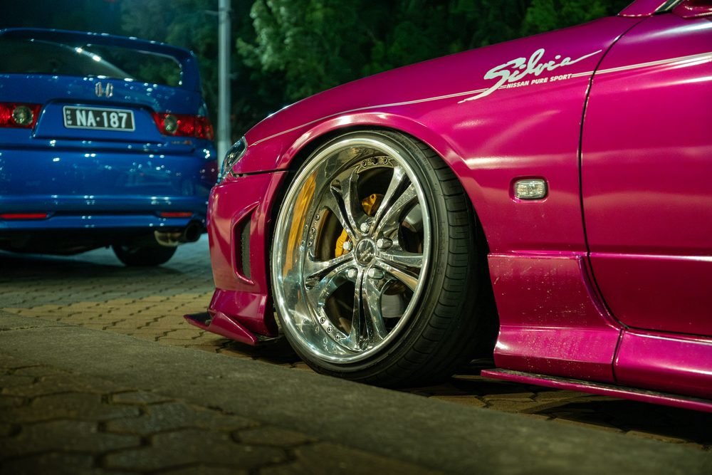 Ferraris, imports and modified cars under carpark lighting at a late-night Sydney car meet (frame 39 of 40)