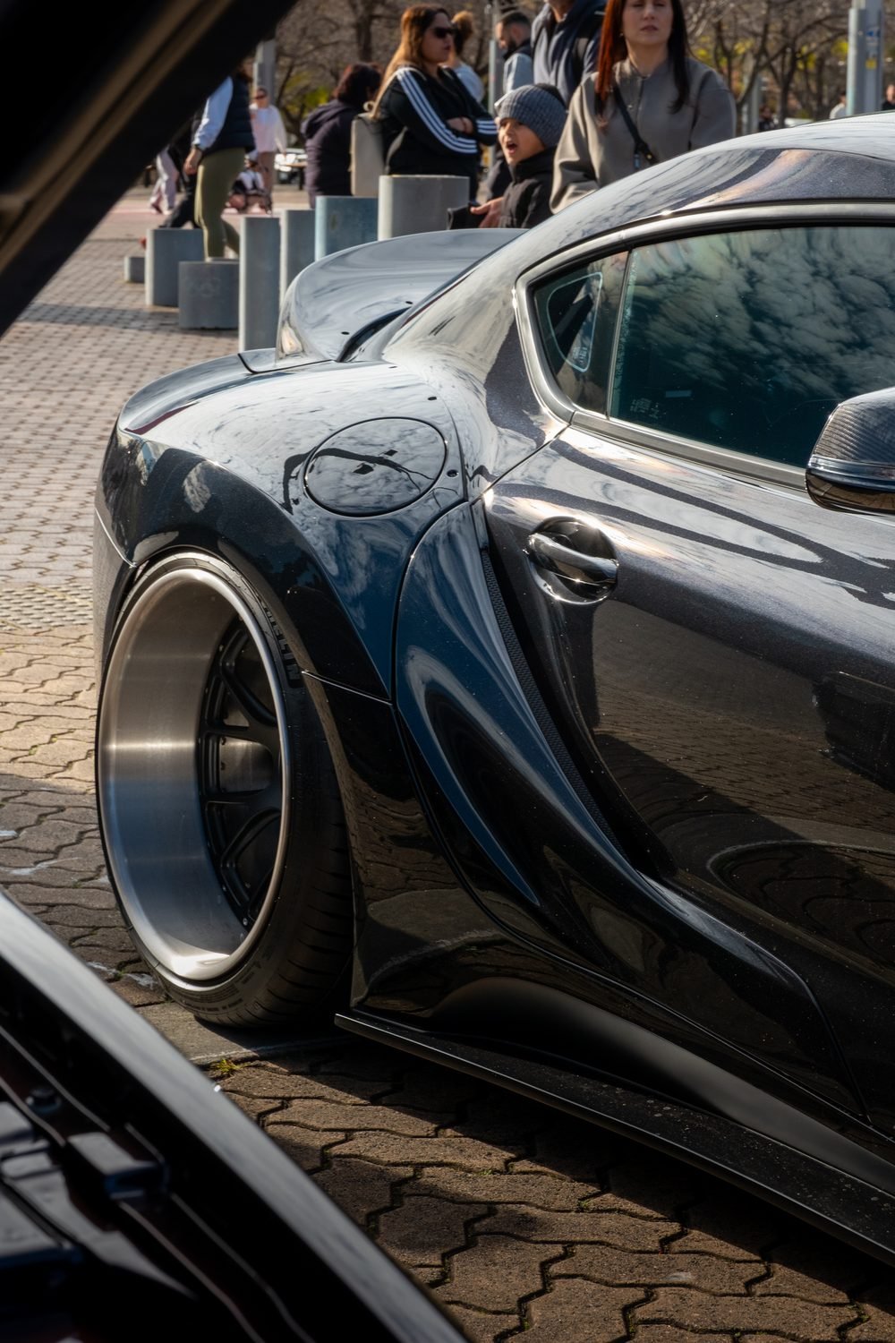 Widebody coupe on polished deep-dish wheels at a Sydney car meet