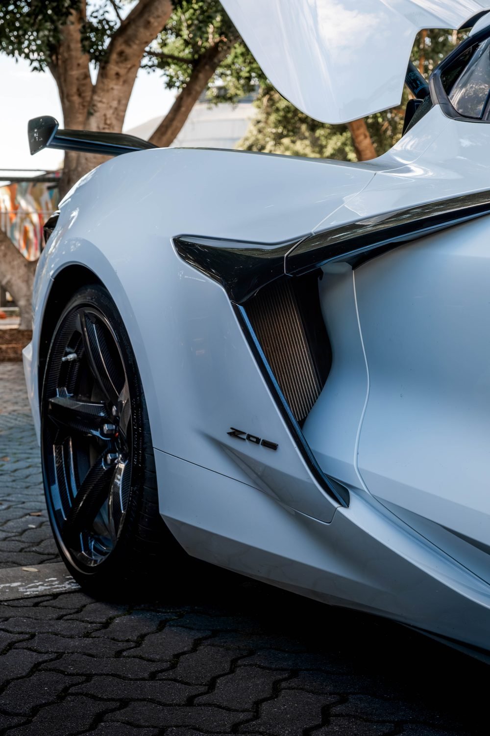 Carbon aero and side intake detail on a white Chevrolet Corvette Z06
