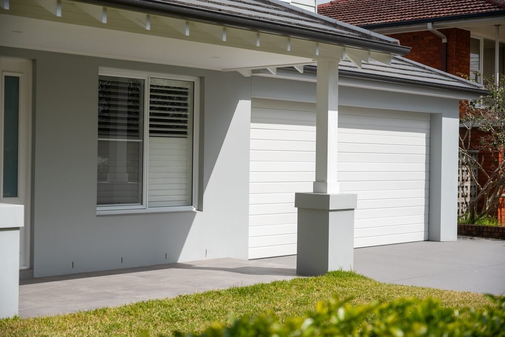 Rendered facade, portico and double garage of a renovated Sydney home