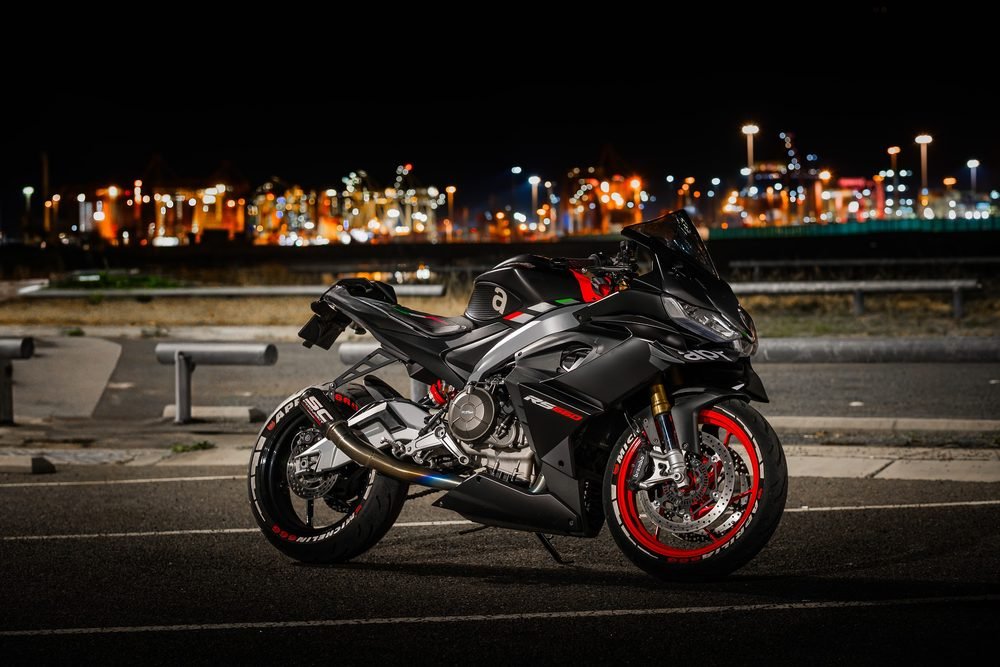 Sportbike photographed from dusk into full dark against Sydney's working harbour (frame 1 of 8)