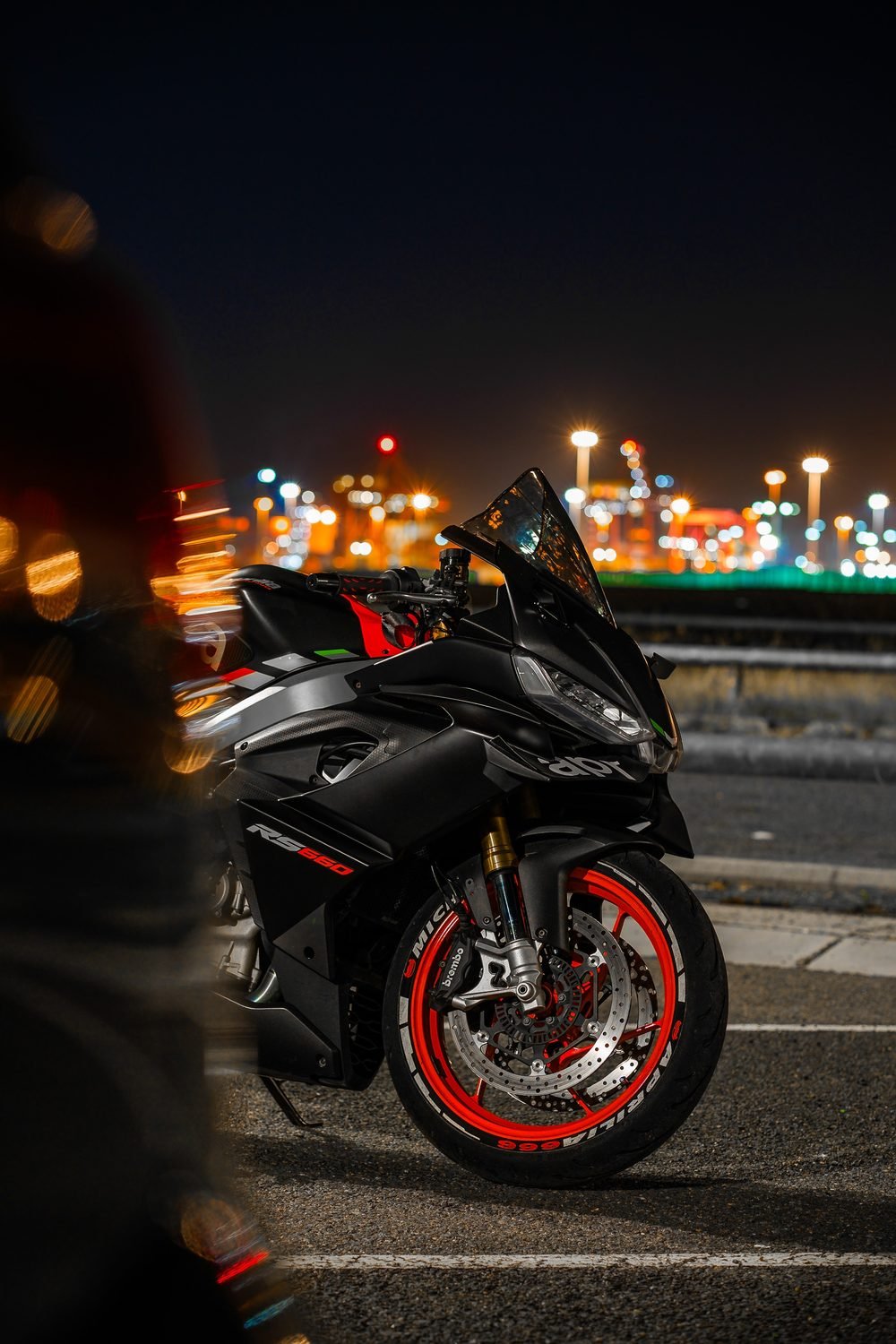 Sportbike lit against the dark at a Sydney harbourside wharf