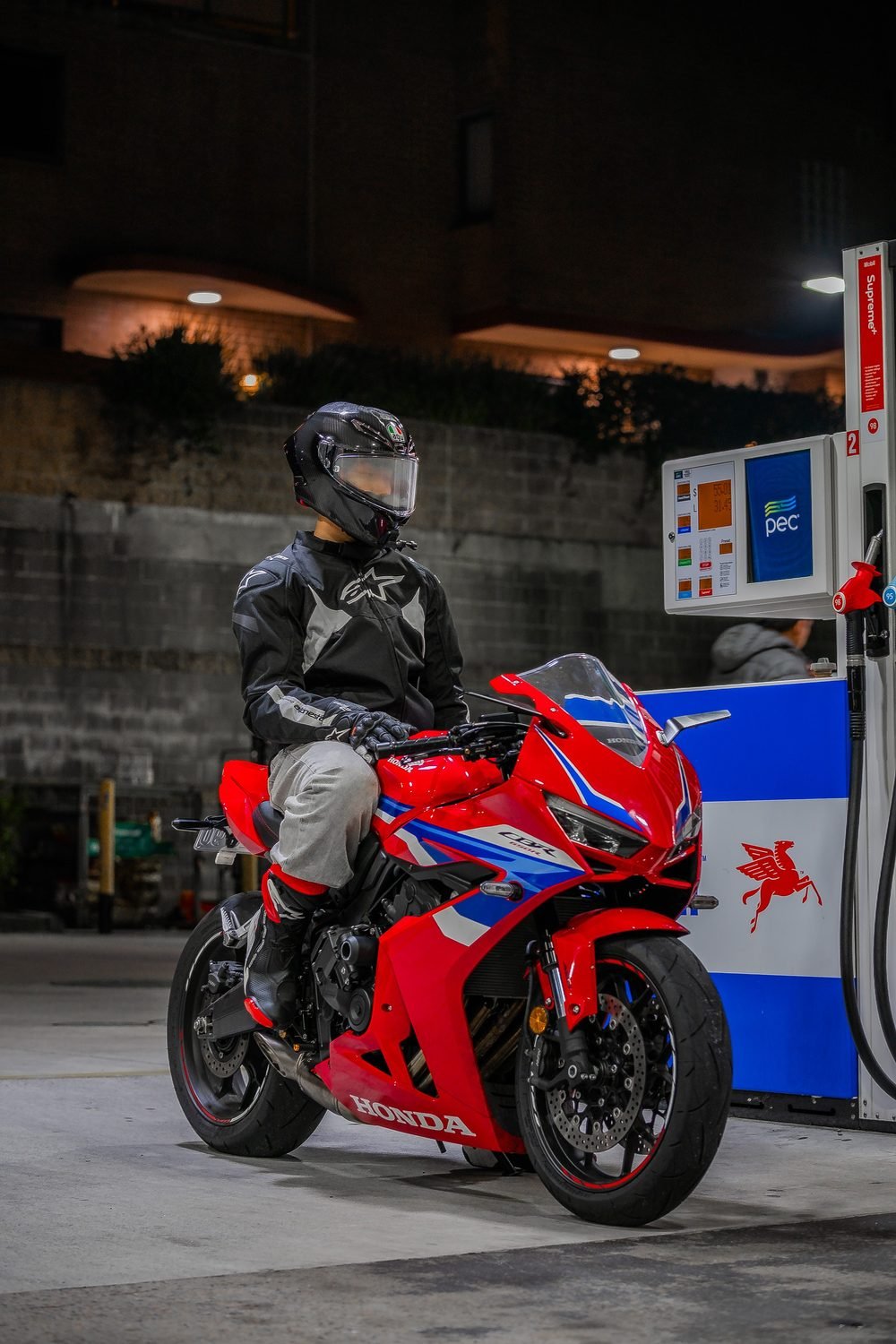 Sportbike photographed from dusk into full dark against Sydney's working harbour (frame 8 of 8)