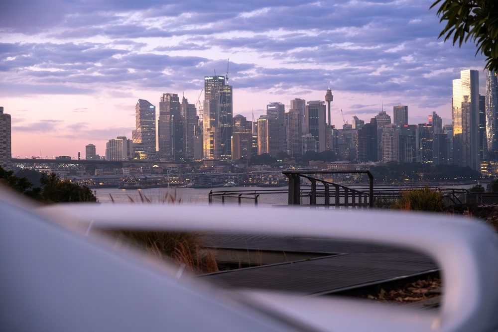 Nissan Skyline GTS photographed against the Sydney city skyline and Harbour Bridge at sunset (frame 2 of 12)