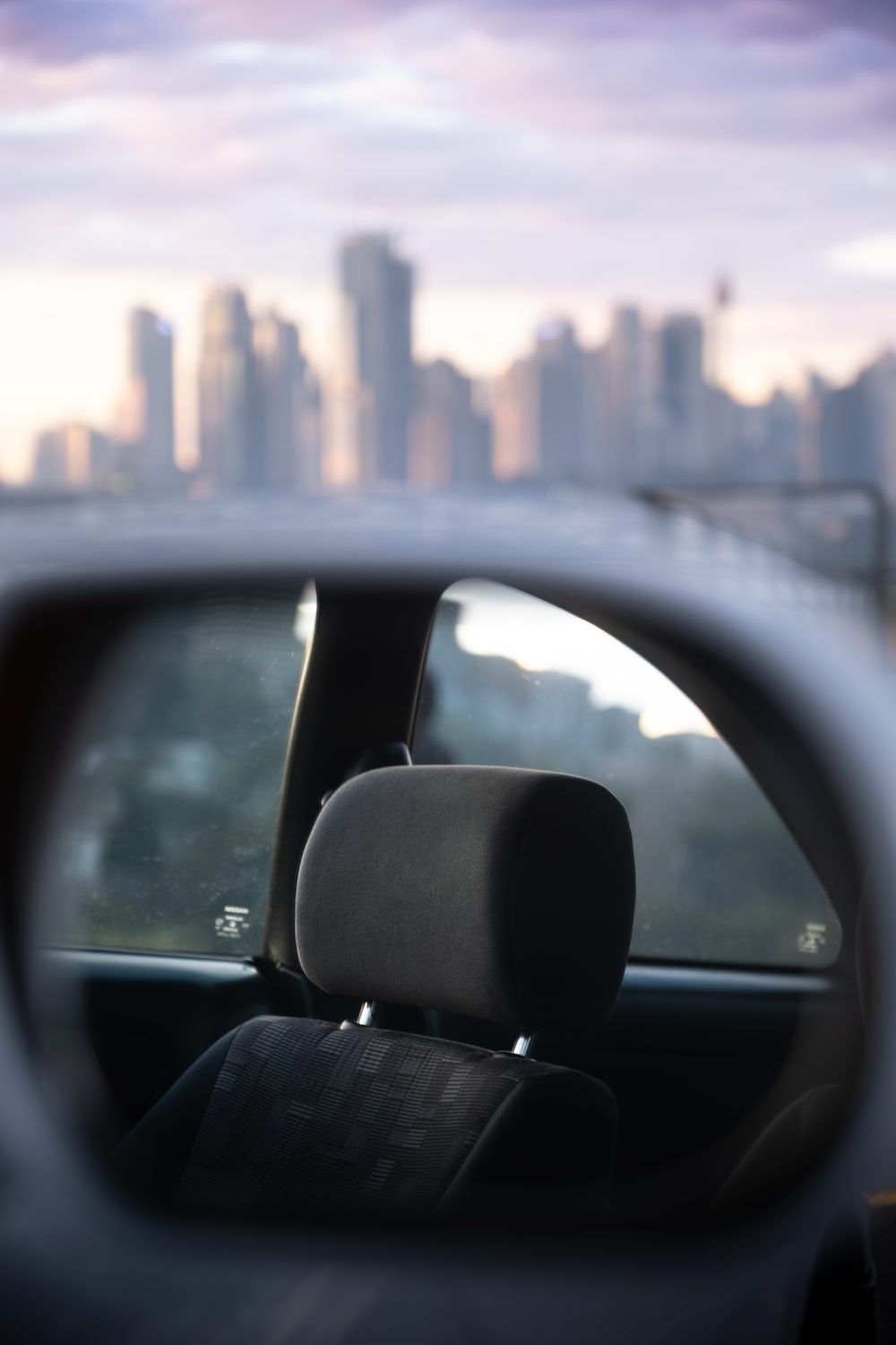 Nissan Skyline GTS photographed against the Sydney city skyline and Harbour Bridge at sunset (frame 9 of 12)