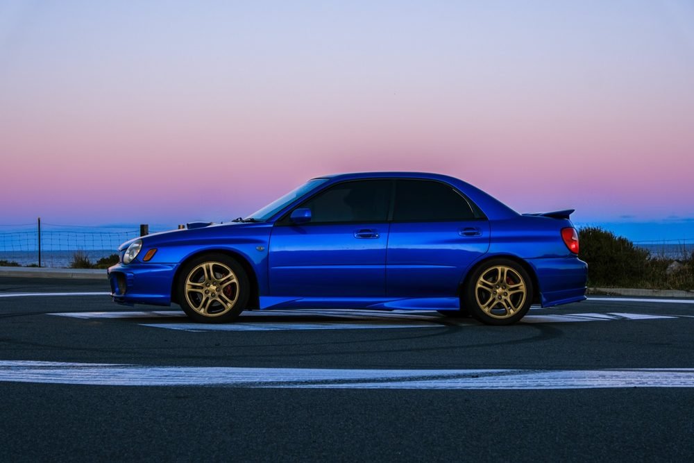Subaru Impreza WRX STI on gold wheels at a New South Wales coastal lookout during blue hour (frame 1 of 12)