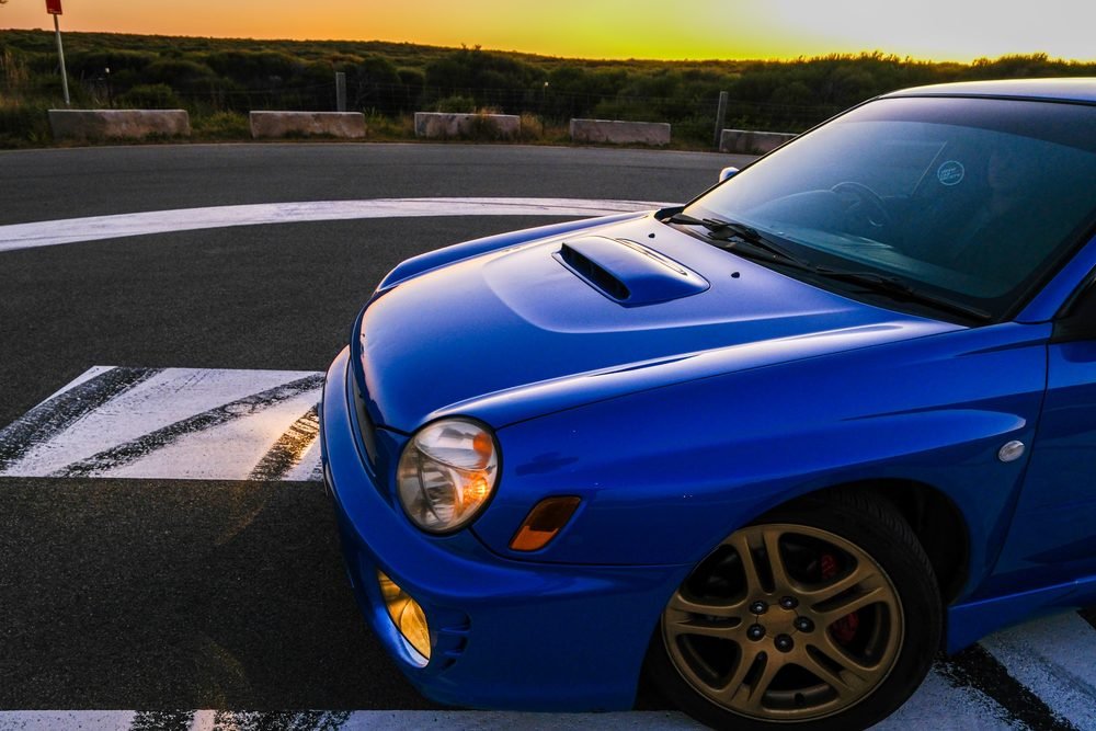 Subaru Impreza WRX STI on gold wheels at a New South Wales coastal lookout during blue hour (frame 5 of 12)
